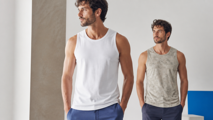 Homem usando regata branca masculina em ambiente clean, com foco em cores e estampas.